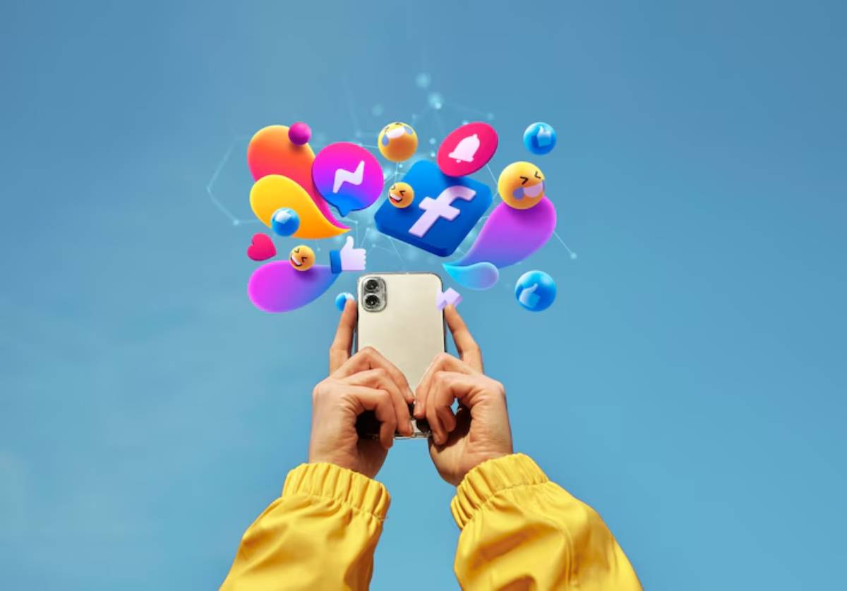 A person in a yellow jacket holds a smartphone with colorful social media icons floating above against a blue sky background.