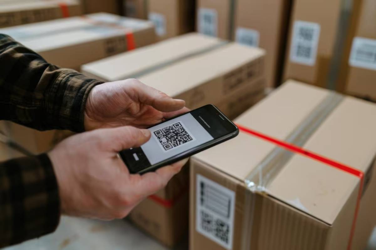 A person scans a QR code on a phone, while another uses their phone.